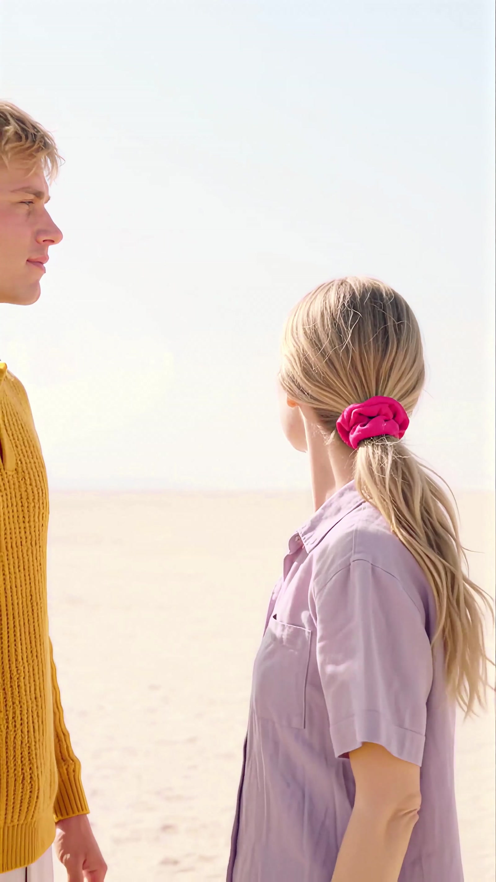 Final shot: she ties her hair with the crimson band